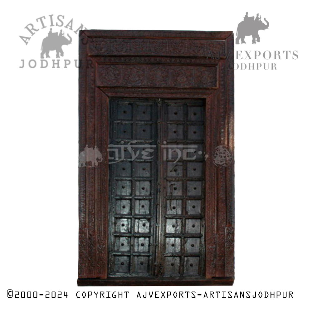 Classic wooden door with geometric patterns and a carved frame, exemplifying Jodhpur artistry.