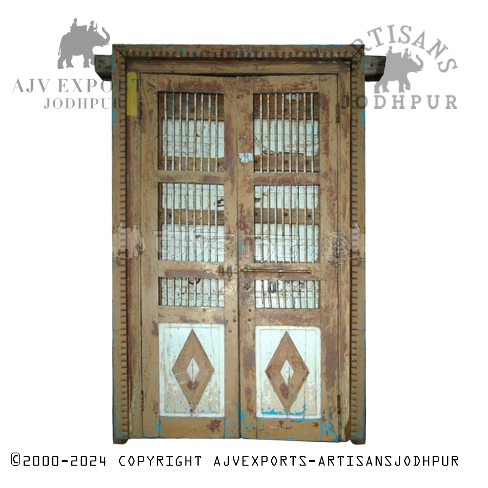 Traditional carved wooden door with brass accents and intricate detailing from Artisans Jodhpur.