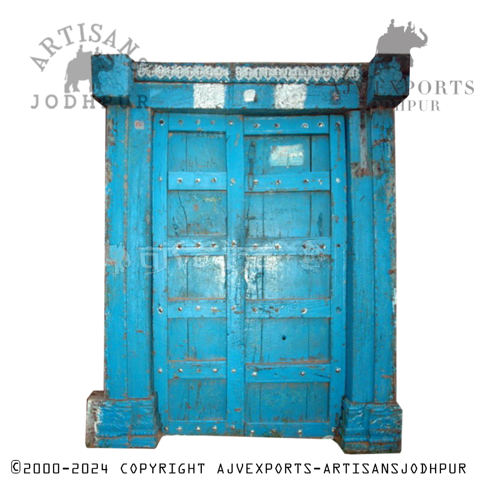 Rustic blue wooden door with metal studs and a distressed finish from Artisans Jodhpur.