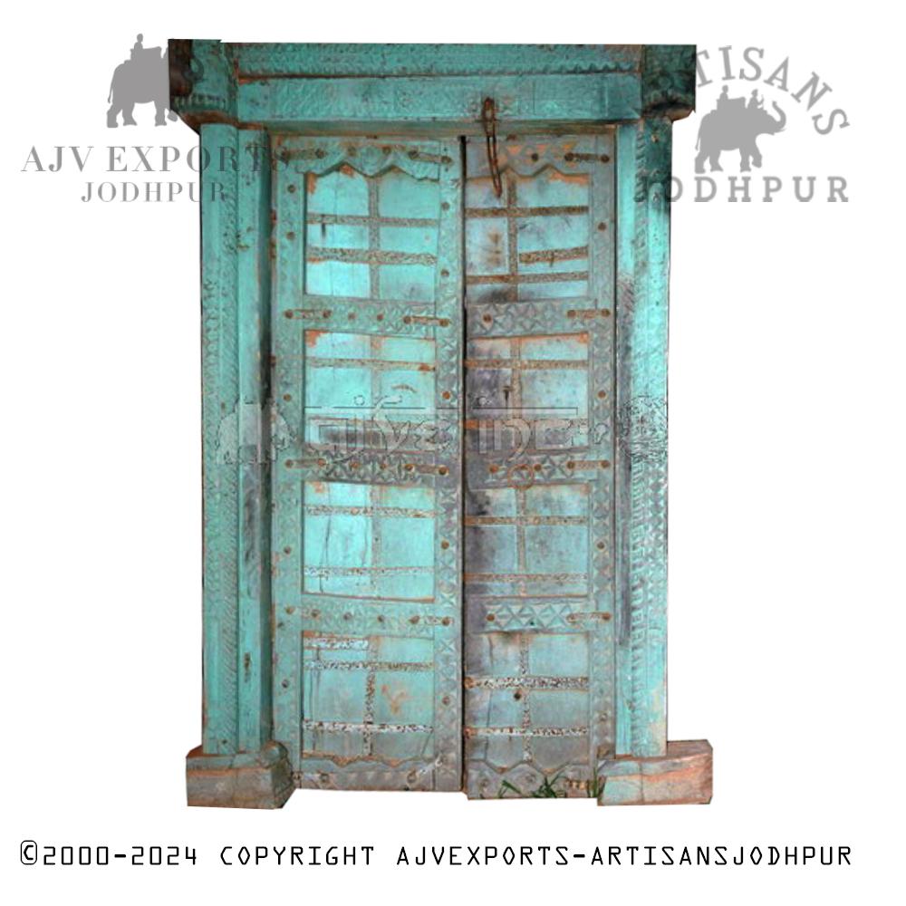 A rustic, turquoise painted metal door with intricate patterns and robust ironwork, perfect for a statement antique entrance.