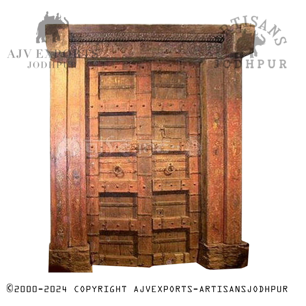 Ornately carved traditional Indian wooden door with metal accents and detailed patterns.