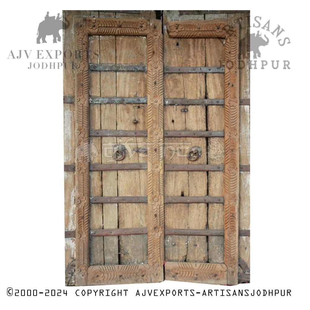 A vintage wooden door from India, surrounded by intricately carved