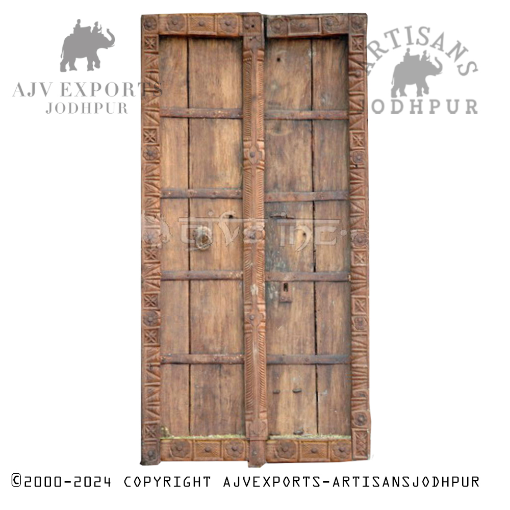 Traditional Indian wooden door surrounded by intricately carved frames.