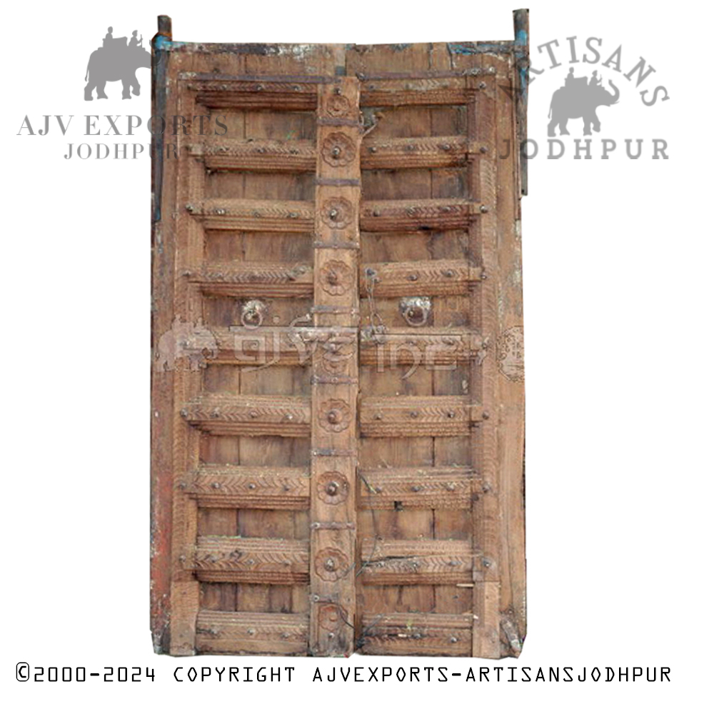 Rustic wooden door from India with deep carved accents and a weathered finish.