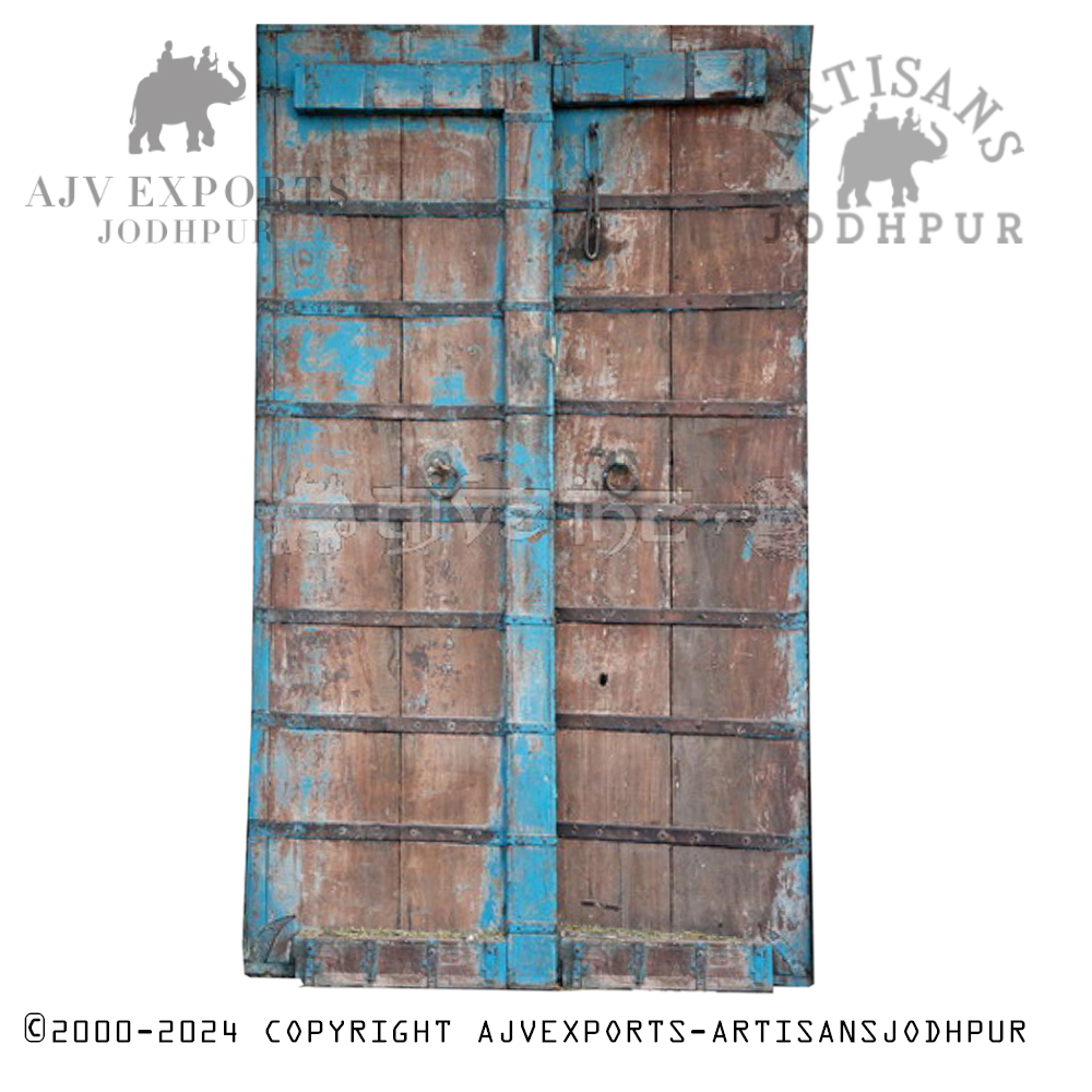 Vibrant blue traditional Indian door with rustic hardware and bold aesthetics.