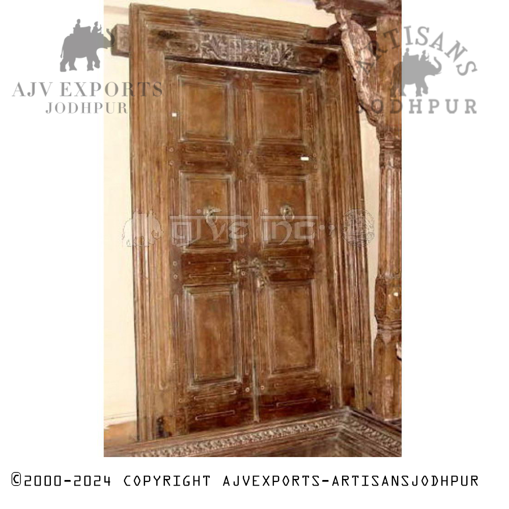 Vintage Indian door with intricately carved panels and traditional patterns.