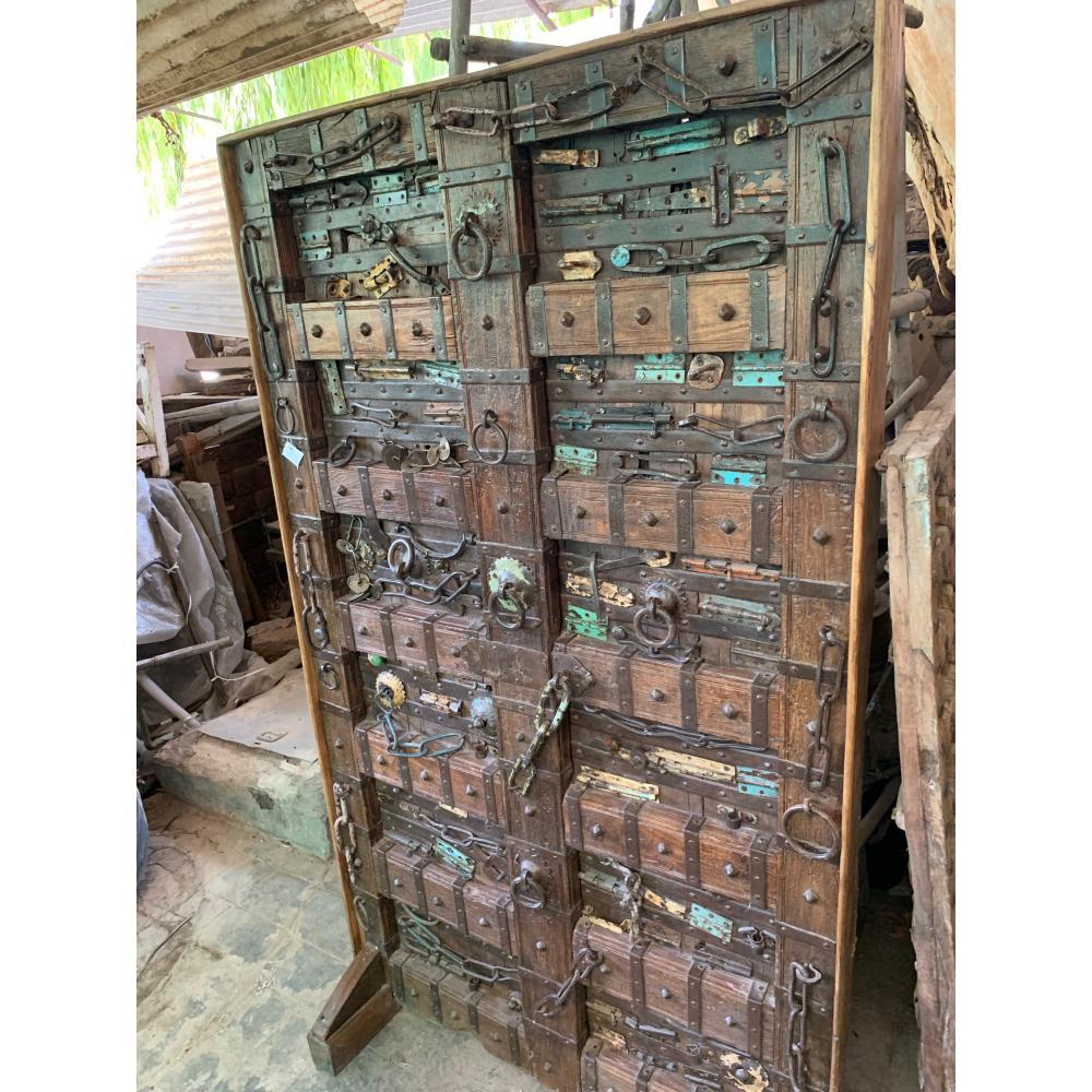 Antique wooden door with metal locks and latches