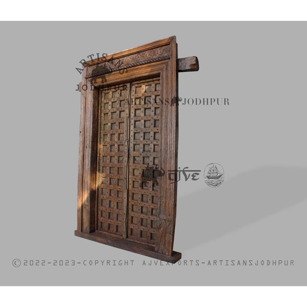 Grand wooden door frame with intricate carvings