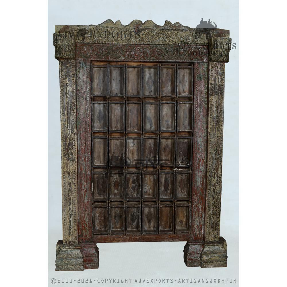 Antique wooden door with heavy iron bolts and carved panels