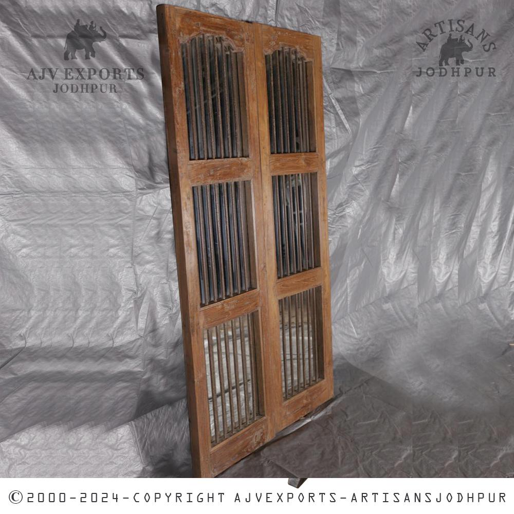 Wooden door with iron bars and arched windows