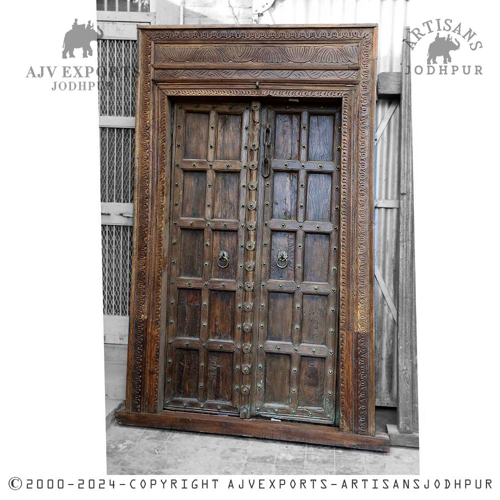 Sturdy wooden door with heavy metal accents and rings