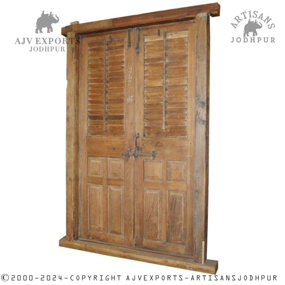 A pair of antique wooden shutter doors, showcasing a rustic patina.