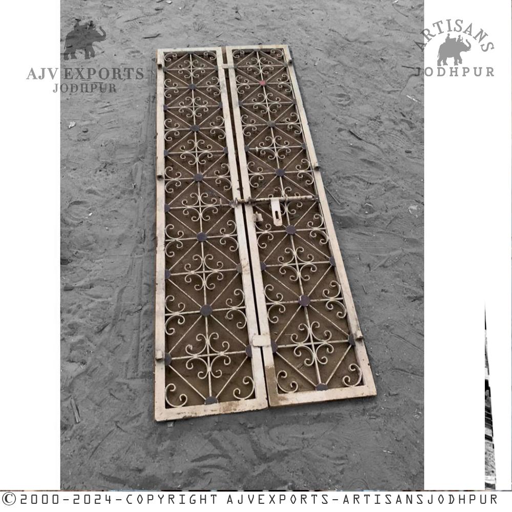 An ornate iron gate with intricate scrollwork, symbolizing the grandeur of traditional Indian architecture.